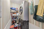 Discover the convenience of this well-organized laundry room, featuring a modern washer and dryer set.