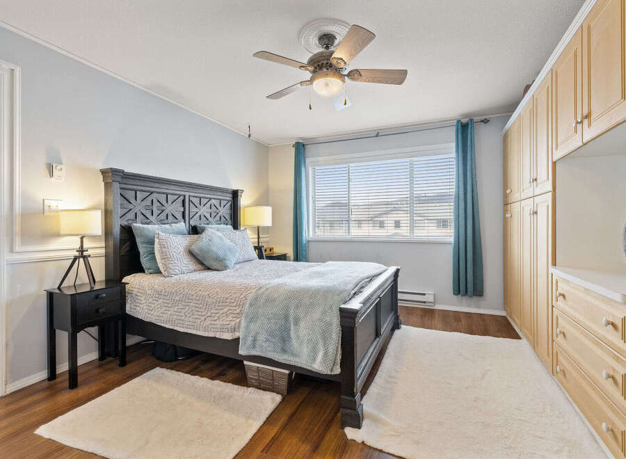 Step into this inviting bedroom, featuring a comfortable bed with stylish bedding and accent pillows.