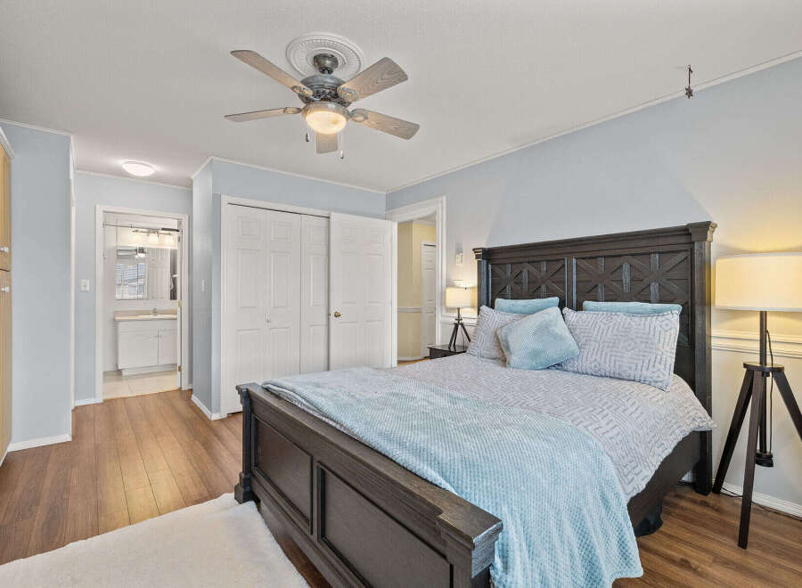 Step into this inviting bedroom, featuring a comfortable bed and ample natural light.