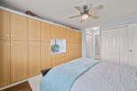 This bedroom boasts ample storage with custom built-in cabinetry, perfect for keeping your space organized.