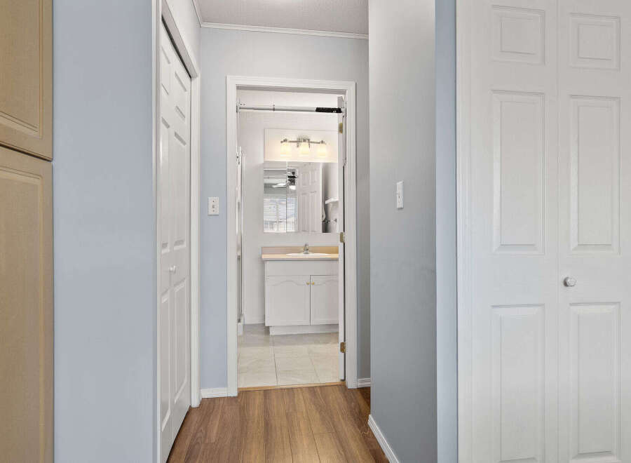 Step into this inviting home and discover a well-designed hallway leading to a bright bathroom.