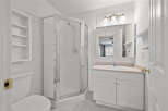 Step into this bright and airy bathroom, featuring a modern glass shower and ample storage.