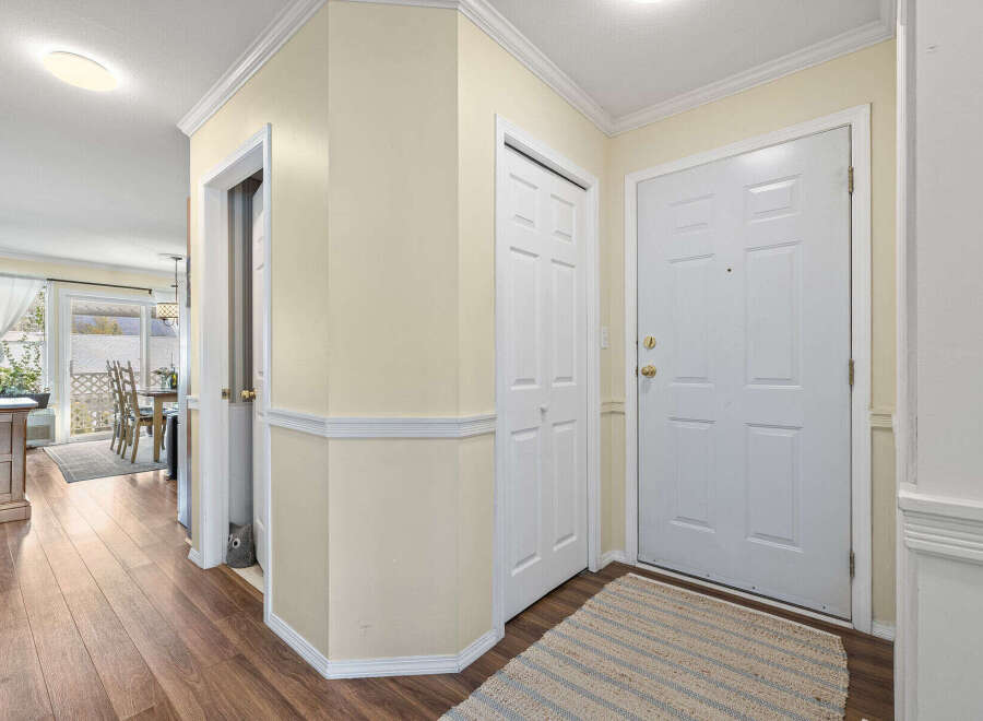 Step into this inviting entryway, showcasing beautiful hardwood floors and a warm, neutral color palette.