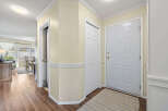 Step into this inviting entryway, showcasing beautiful hardwood floors and a warm, neutral color palette.