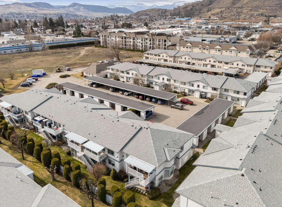 Discover a stunning residential property featuring modern townhouses with ample parking and well-maintained exteriors.