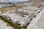 Discover a stunning residential property featuring modern townhouses with ample parking and well-maintained exteriors.