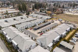 Discover a charming residential complex featuring well-maintained townhouses with ample parking and covered carports.