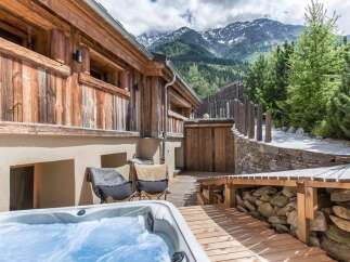 Escape to your own mountain retreat! This stunning property boasts a luxurious hot tub, perfect for relaxing after a day of exploring the surrounding natural beauty.