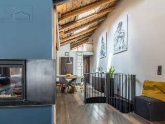 Discover the charm of this stunning property, featuring a unique architectural design with exposed wooden beams and a cozy fireplace.