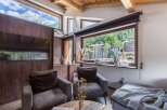 Discover the charm of this cozy living space, featuring stunning mountain views framed by large windows.