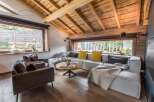 This stunning living room boasts a rustic charm with its wooden ceiling and flooring, creating a warm and inviting atmosphere.