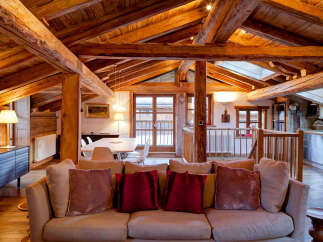 Experience the charm of this stunning property, featuring a rustic wooden ceiling and exposed beams that create a warm and inviting atmosphere.