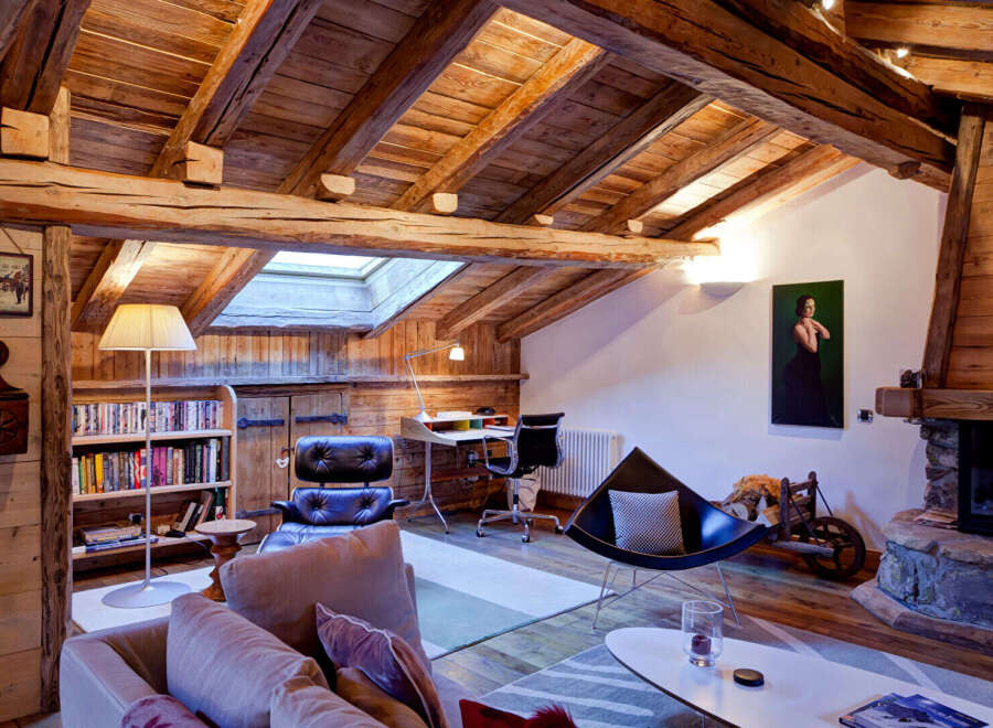 This stunning property boasts a rustic charm with its exposed wooden beams and cozy fireplace, creating a warm and inviting atmosphere.