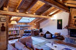 This stunning property boasts a rustic charm with its exposed wooden beams and cozy fireplace, creating a warm and inviting atmosphere.