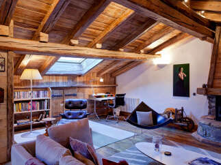 This stunning property boasts a rustic charm with its exposed wooden beams and cozy fireplace, creating a warm and inviting atmosphere.