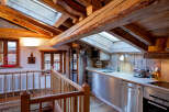 Experience rustic charm in this stunning property featuring exposed wooden beams and a cozy kitchen.