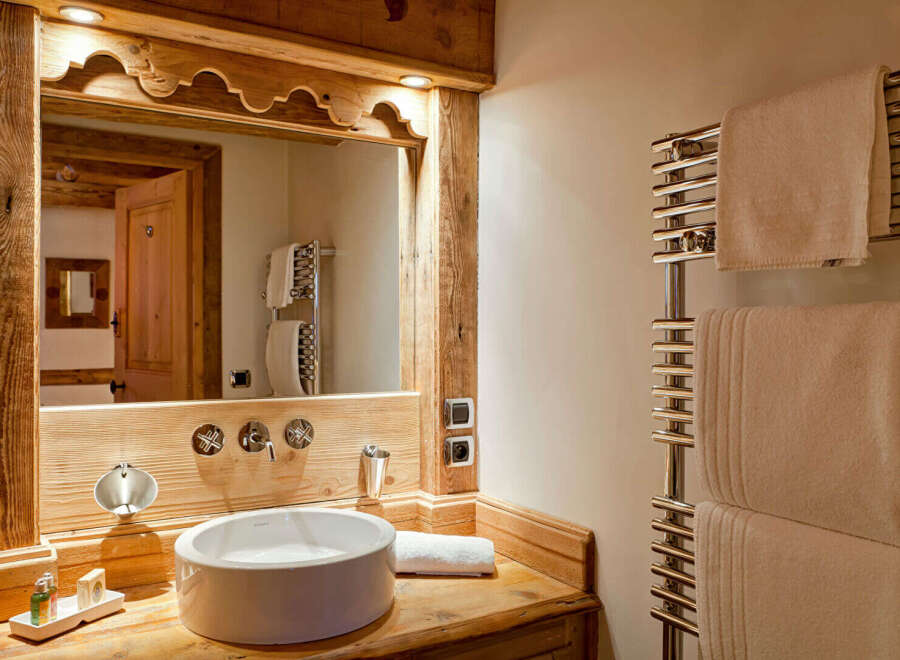 This stunning bathroom features a rustic wooden vanity with a modern sink, creating a perfect blend of style and functionality.
