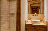 This rustic bathroom features a charming blend of natural elements.