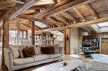 Experience rustic luxury in this charming mountain retreat, featuring exposed wooden beams and a cozy living area.