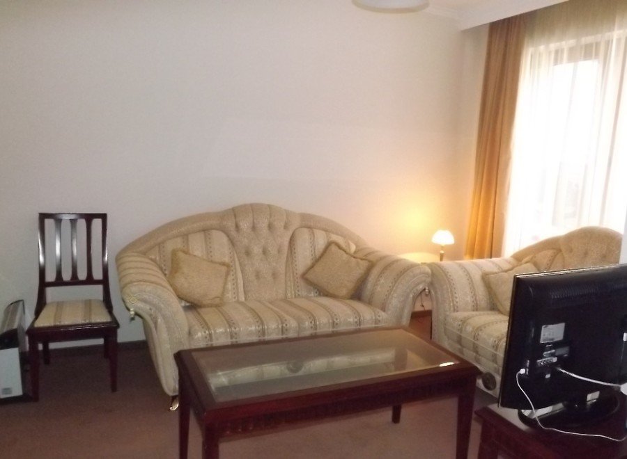 Cozy living room featuring a comfortable sofa and chair, perfect for relaxing after a long day.