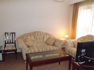 Cozy living room featuring a comfortable sofa and chair, perfect for relaxing after a long day.
