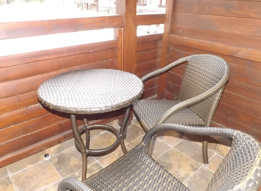 Enjoy your morning coffee on this charming balcony, complete with a cozy wicker table and chairs.