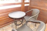 Enjoy your morning coffee on this charming balcony, complete with a cozy wicker table and chairs.