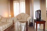 Relax in this comfortable living room, featuring plush sofas and a convenient coffee table.