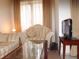Relax in this comfortable living room, featuring plush sofas and a convenient coffee table.