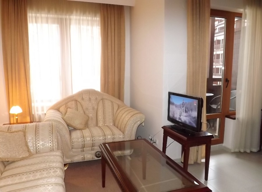 Cozy living room with comfortable sofas and large windows offering plenty of natural light.