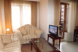 Cozy living room with comfortable sofas and large windows offering plenty of natural light.