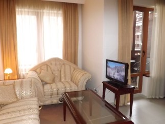 Cozy living room with comfortable sofas and large windows offering plenty of natural light.