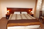 Relax in our comfortable hotel room, featuring a plush king-size bed with a luxurious comforter and crisp linens.