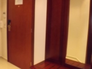 This stunning property boasts a spacious entryway with a built-in wooden bench and mirror, perfect for organizing your belongings and adding a touch of elegance to your home.