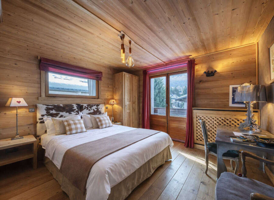 Experience the warmth and charm of this stunning bedroom, featuring exquisite wooden paneling throughout.