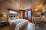 Experience the warmth and charm of this stunning bedroom, featuring exquisite wooden paneling throughout.