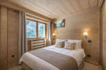 This cozy bedroom features a warm wooden interior, creating a rustic and inviting atmosphere.