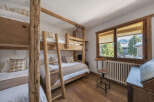 This charming bedroom features rustic wooden bunk beds, perfect for a family or group.