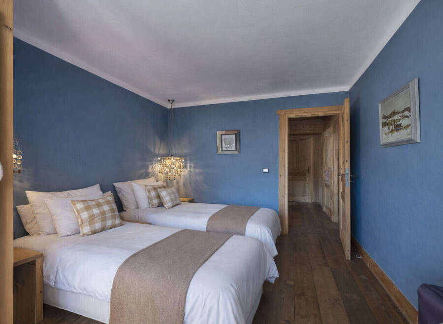 This charming bedroom features two twin beds, perfect for guests or a cozy shared space.