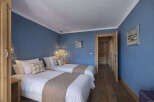 This charming bedroom features two twin beds, perfect for guests or a cozy shared space.