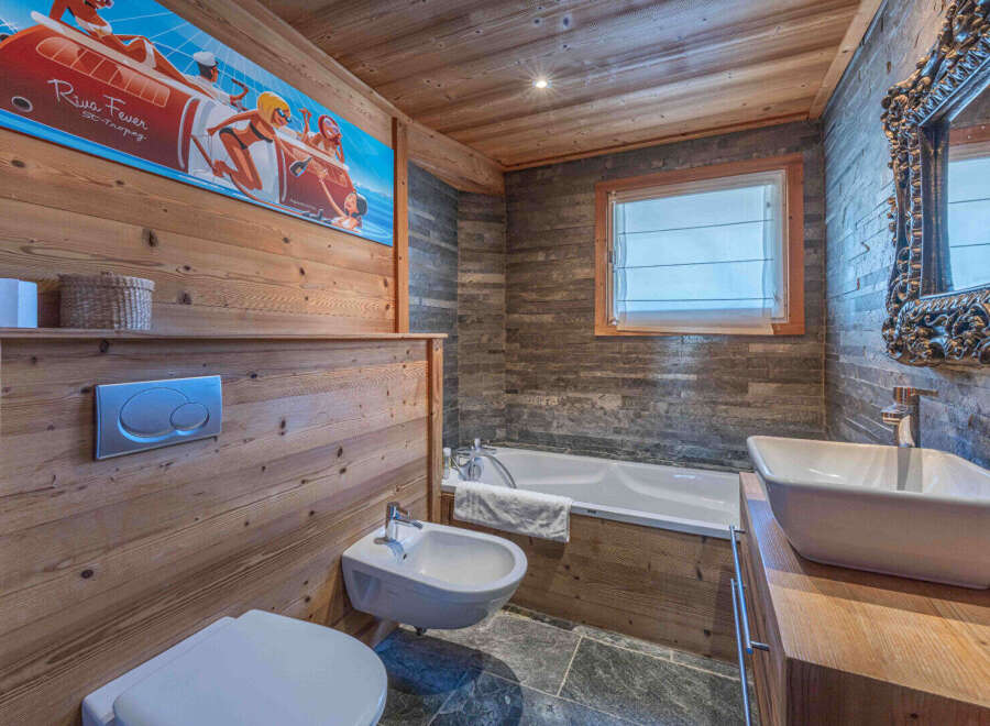 This stunning bathroom features a unique blend of rustic charm and modern design.