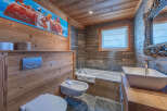 This stunning bathroom features a unique blend of rustic charm and modern design.