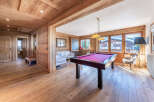 Experience luxury mountain living in this stunning chalet, featuring a dedicated games room with a vibrant pool table perfect for evening entertainment.
