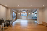 This stunning property boasts a spacious open-plan living area with beautiful wooden flooring throughout.
