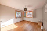 This charming room features beautiful wooden floors and ample natural light, creating a warm and inviting atmosphere.