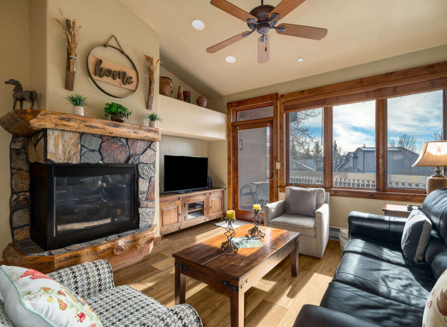 Step into this inviting living space, featuring a cozy fireplace and a stylish entertainment center.