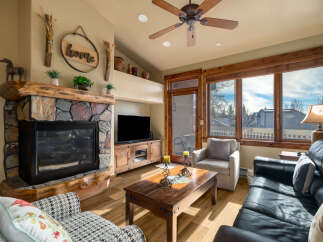 Step into this inviting living space, featuring a cozy fireplace and a stylish entertainment center.