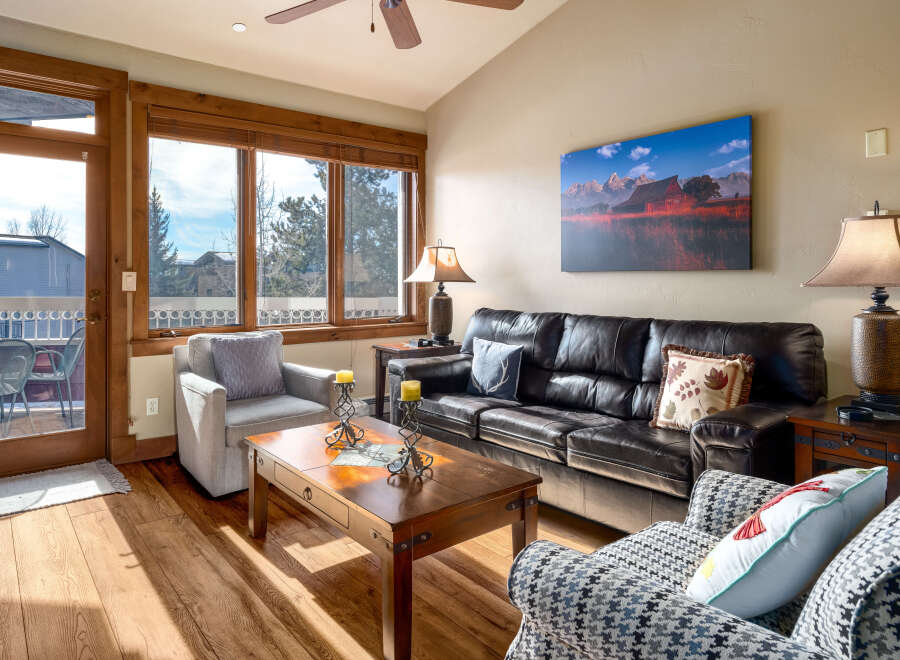 Step into this inviting living space, featuring a cozy seating area and a stunning view through large windows.