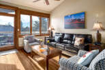 Step into this inviting living space, featuring a cozy seating area and a stunning view through large windows.