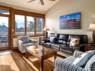 Step into this inviting living space, featuring a cozy seating area and a stunning view through large windows.